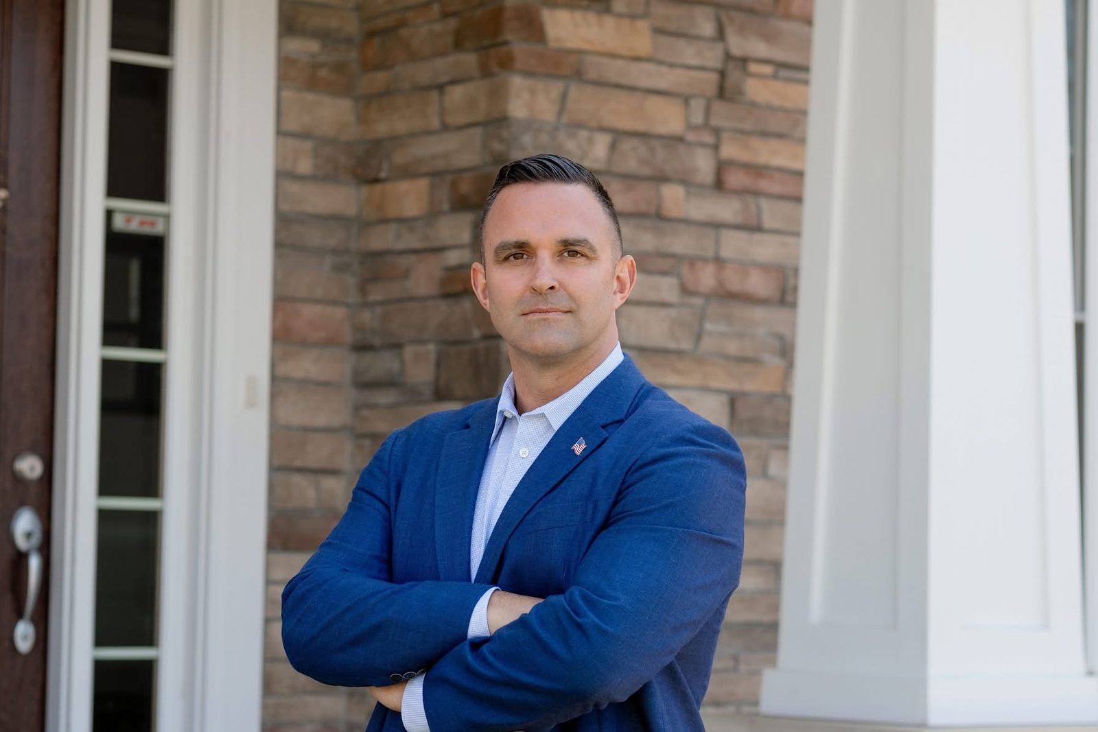 Portrait of Dr. Garrett Soldano in a blue blazer with arms crossed