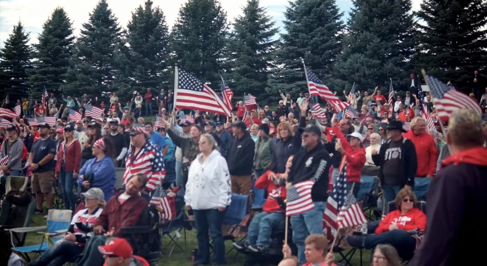 Rally crowd waving American flags